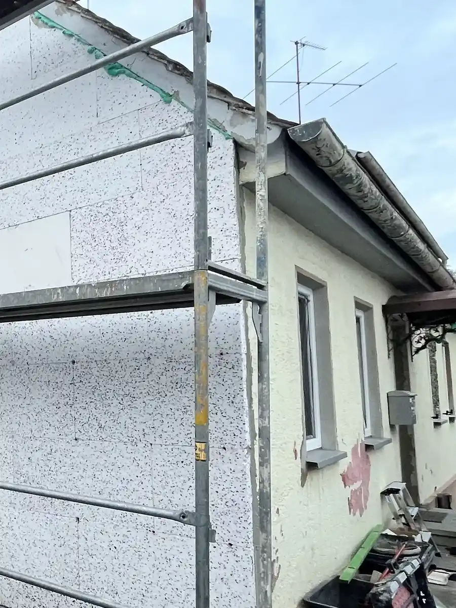 Energetische Modernisierung in Augsburg: Montage der WDVS-Dämmplatten an der Hausfassade